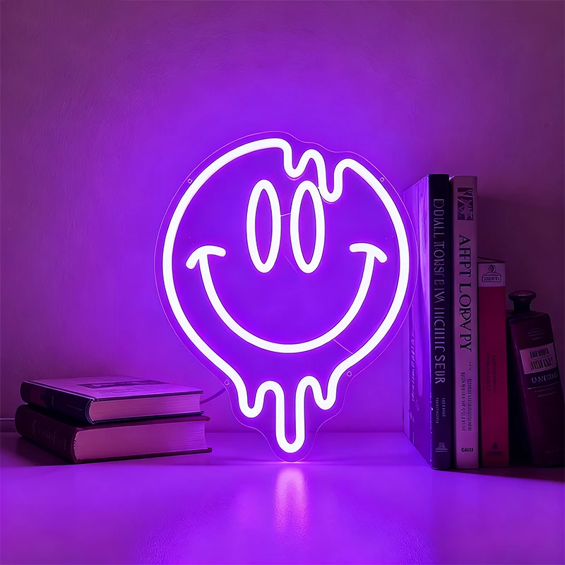 Neon light shaped like a smiley face with a purple glow on a shelf.