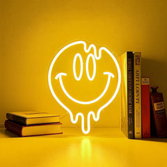 Neon light shaped like a smiley face on a lemon yellow background with books.