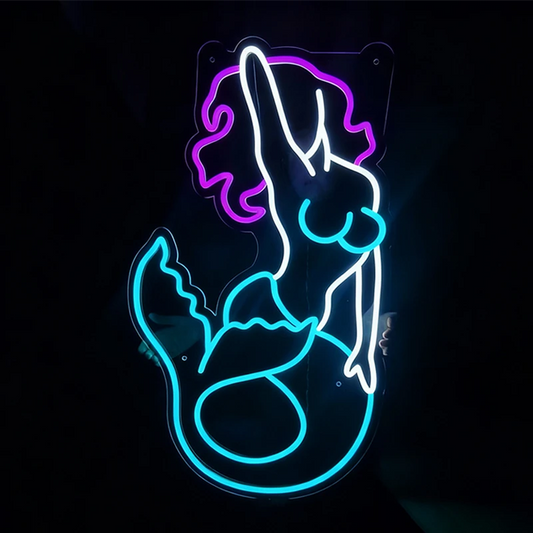 Neon sign of a mermaid silhouette on a black background