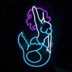 Neon sign of a mermaid silhouette on a black background