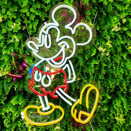 Neon sign of a cartoon character mickey mouse  in red shorts and yellow shoes on a grass background