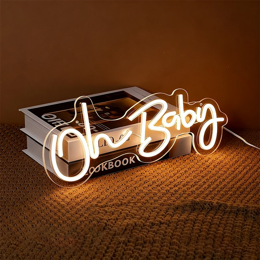 Neon sign with 'Oh Baby' text on a textured surface