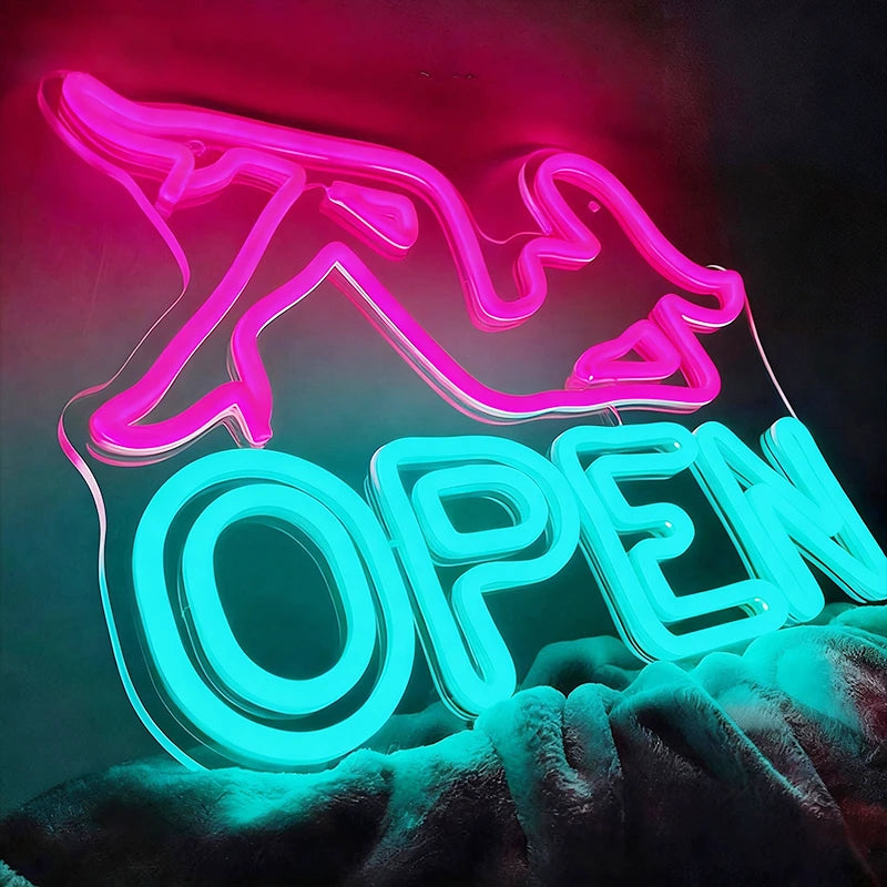 Neon sign with pink woman shape and ice blue 'OPEN' text on a dark background