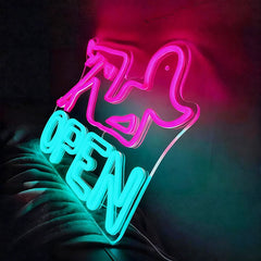 Neon sign with pink and green colors on a dark background