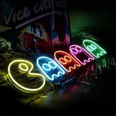 Neon sign with colorful pac-man ghosts on a dark background
