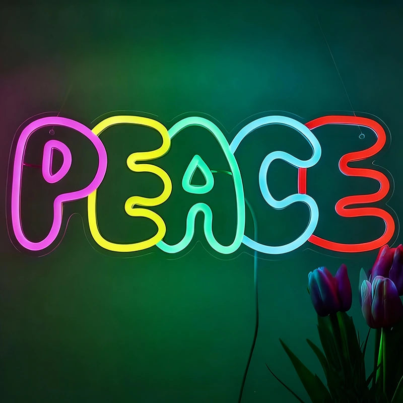 Neon sign spelling 'PEACE' with colorful lights on a dark background