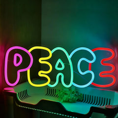 Neon sign with the word 'PEACE' in colorful letters on a dark background