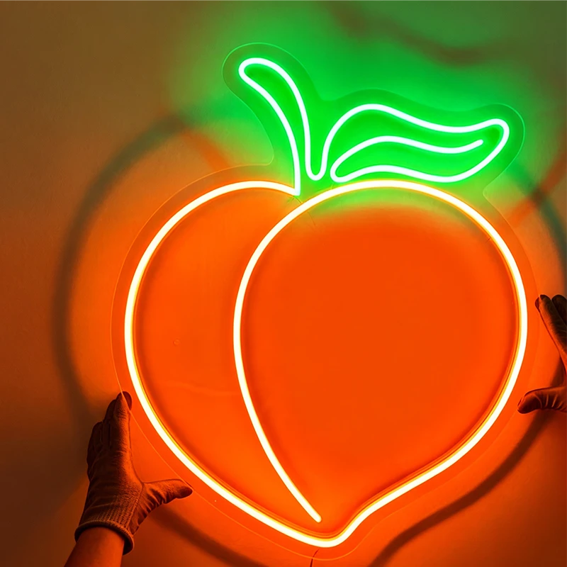 Neon sign shaped like a peach with a hand reaching towards it