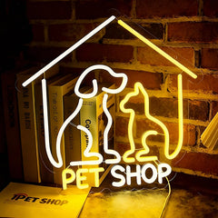 Neon sign shaped like a pet house with a dog and cat silhouette and 'Pet Shop' text, against a brick wall.