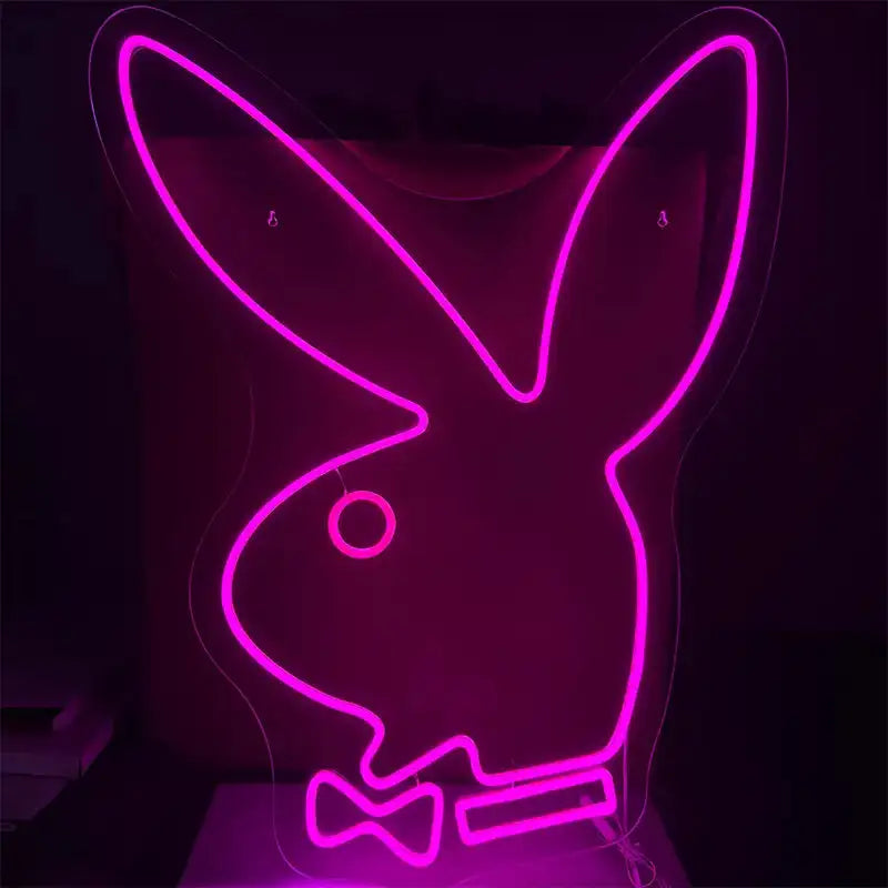 Neon pink outline of a rabbit with a bow tie on a black background