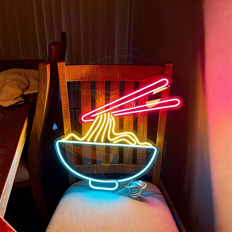 Neon sign of a bowl of noodles on a wooden chair with a dark background