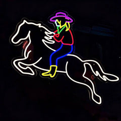 Neon sign of a cowboy riding a horse on a black background