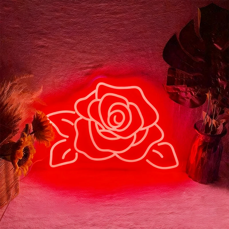 Neon red rose light on a textured wall with decorative elements
