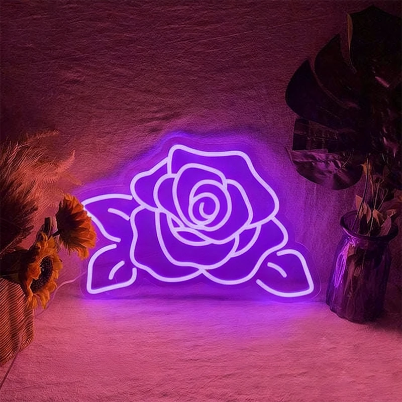 Neon purple rose light on a textured wall with decorative plants.