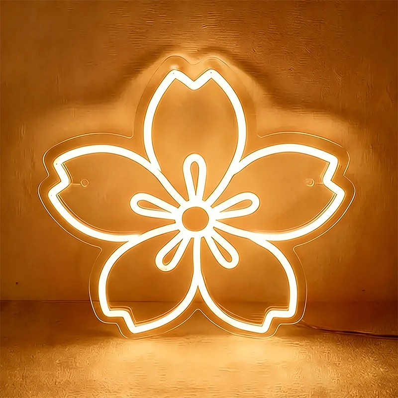 Warm white neon sakura cherry blossom light on a textured brown background.