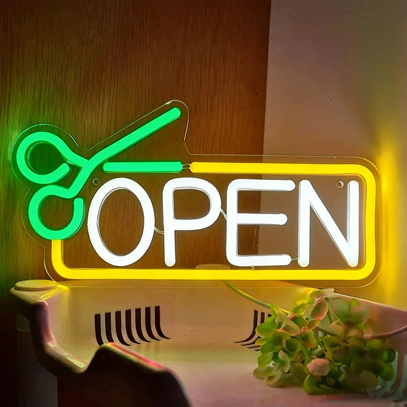 Neon sign with green scissors and white 'OPEN' text on a wooden background