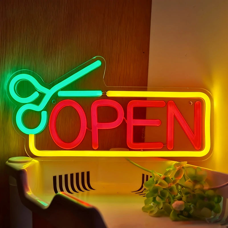 Neon sign with green scissors and red 'OPEN' text on a wooden background