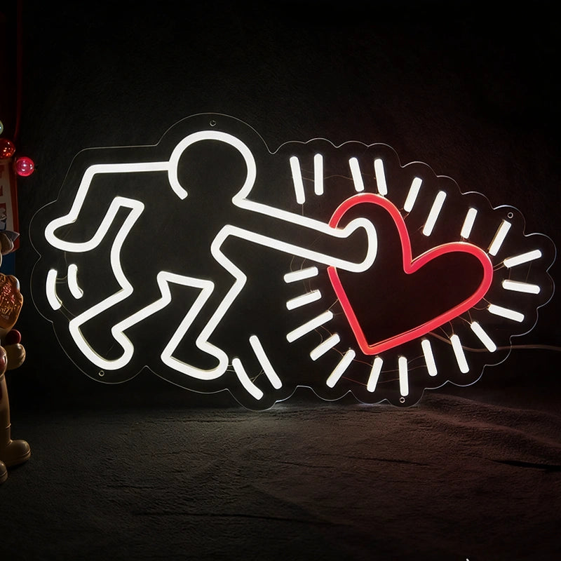 Neon sign with a figure holding a heart on a dark background