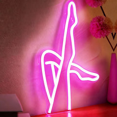 Neon sign of legs on a pink background