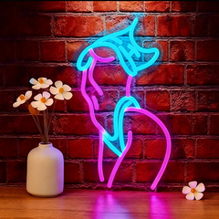 Neon sign of a Woman Body with pink and blue colors on a brick wall background