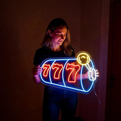 Person holding a neon sign shaped like a slot machine with '777' on a dark background