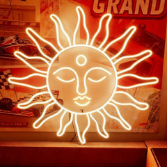 Warm white neon sun-shaped sign with face design in front of a racing-themed poster