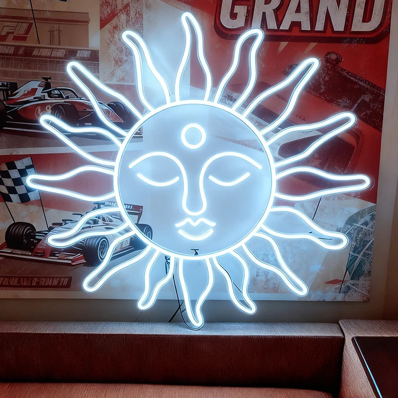 White neon sun-shaped sign with face design in front of a racing car poster.