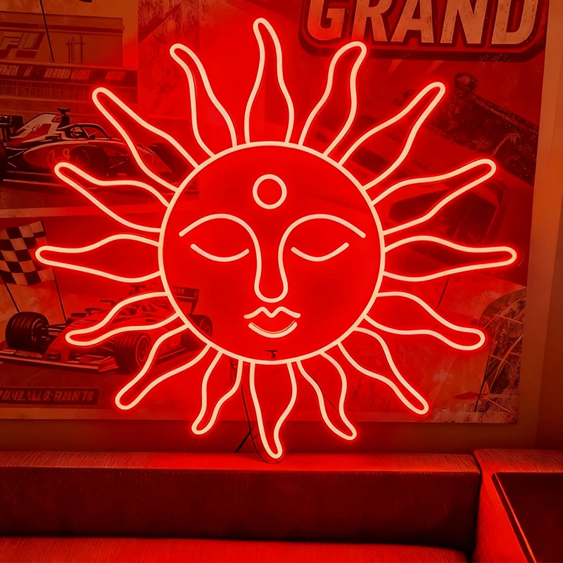 Neon sun-shaped sign with face design on a red background