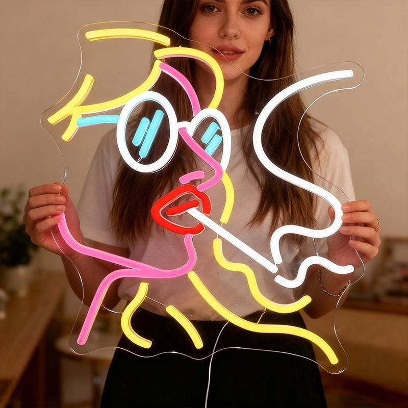 Person holding a colorful neon sign shaped like a person