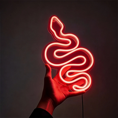 Neon red light shaped like a snake held in a hand against a dark background