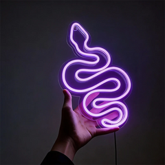 Neon purple light shaped like a snake held in a hand against a dark background