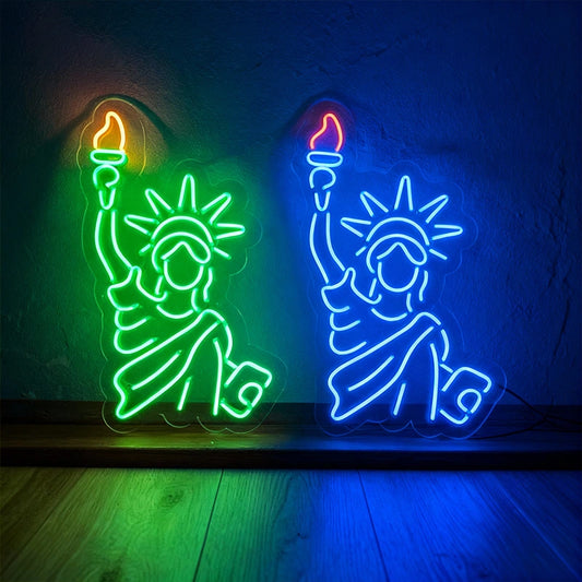 Two neon signs of the Statue of Liberty on a dark background