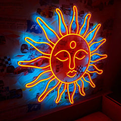 Neon sun-shaped light fixture with face design on a colorful background