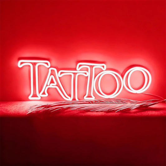 Neon sign with 'Tattoo' text on a red background