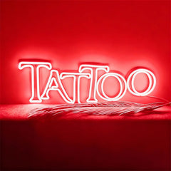 Neon sign with 'Tattoo' text on a red background