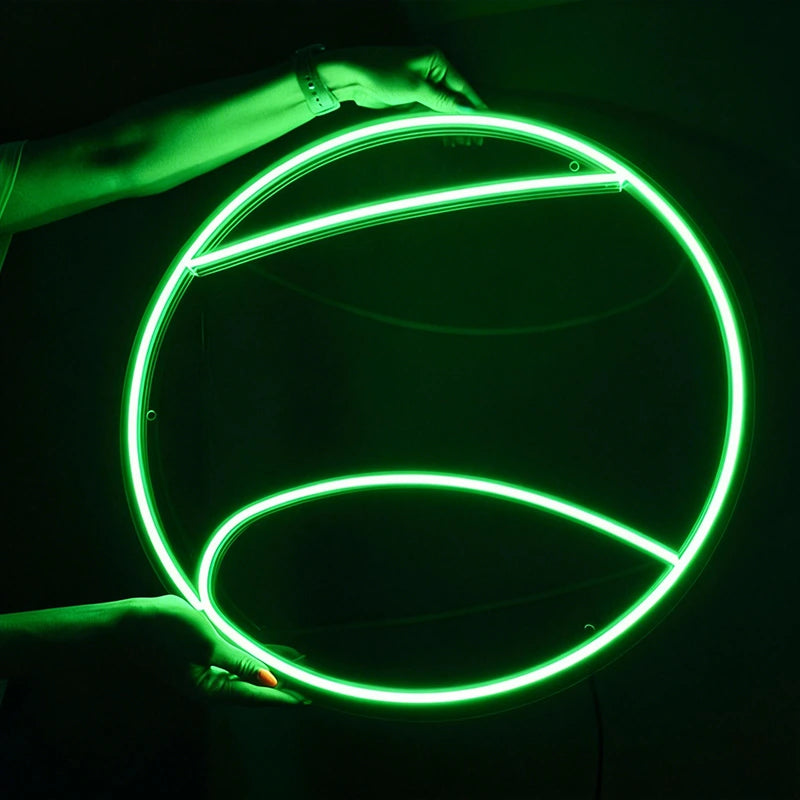 Green neon tennis ball glowing brightly against a dark background