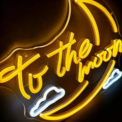 Neon sign with 'To the moon' text in yellow on a dark background