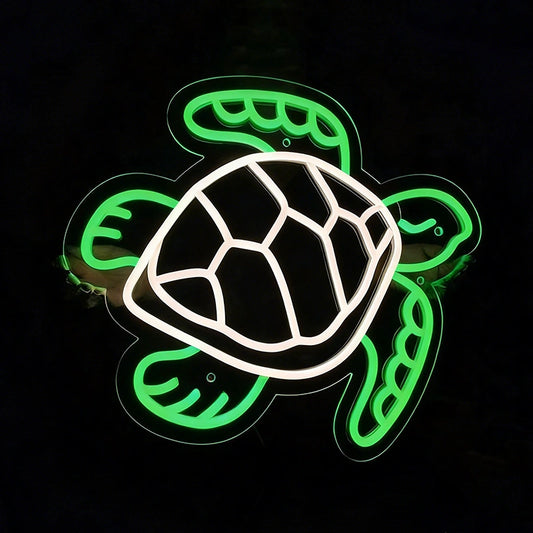 A neon-style turtle sign with a glowing green outline and a white shell, photographed against a black background.