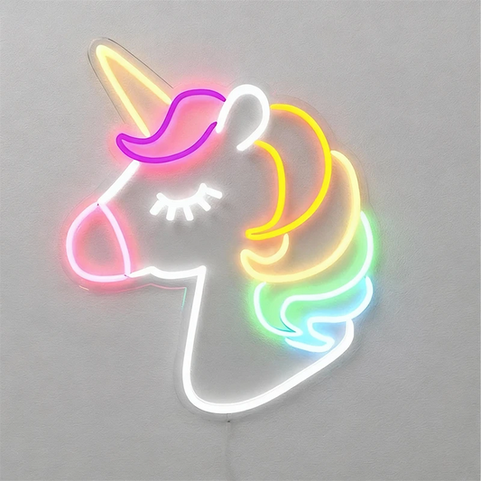 Neon sign shaped like a unicorn head on a plain background