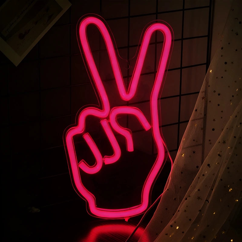 Neon sign of a hand making a peace sign on a dark background
