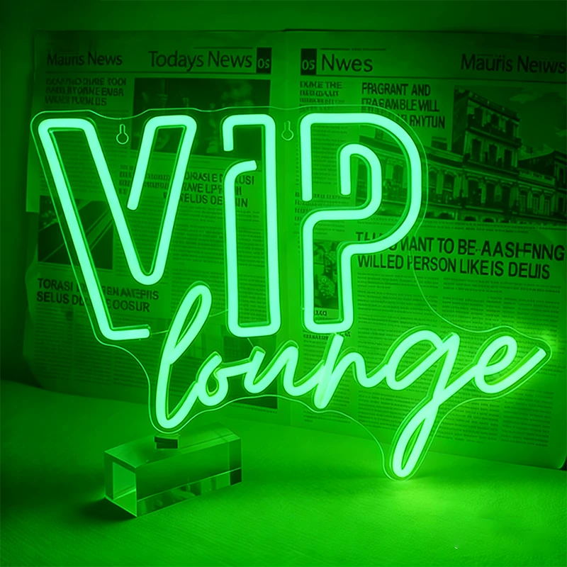 Neon sign with 'VIP lounge' text on a green background