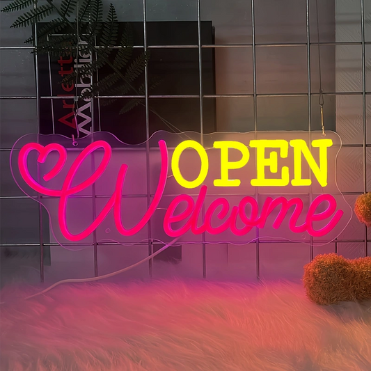 Neon sign with 'OPEN Welcome' text next to a teddy bear on a tiled wall.