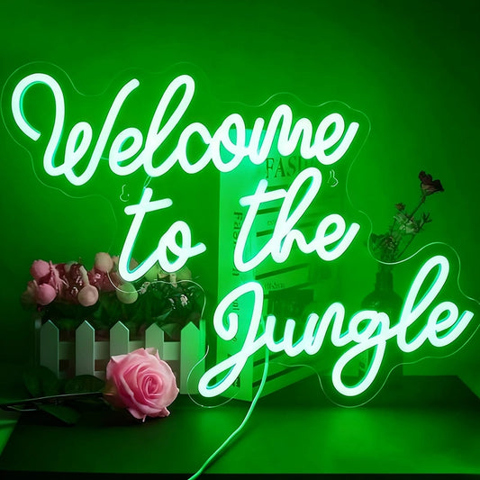 Neon sign with 'Welcome to the Jungle' text on a green background with decorative elements.