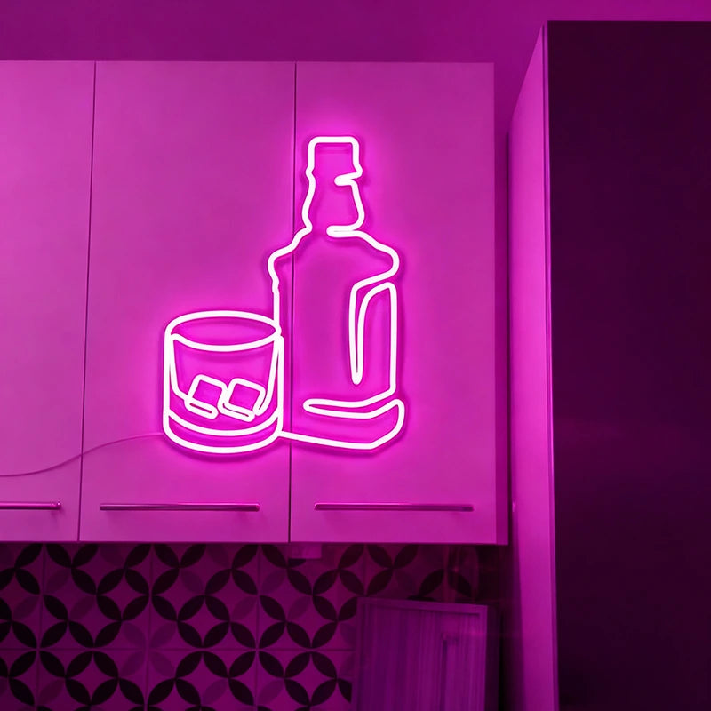 Neon sign of a bottle and glass with ice on a purple wall.