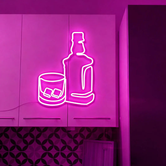Neon sign of a bottle and glass with ice on a purple wall.