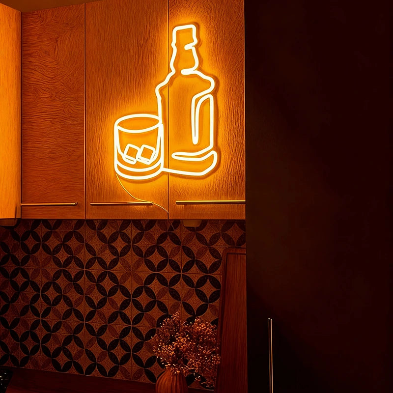 Neon sign of a bottle and glass on a wooden panel with a dark patterned wall.