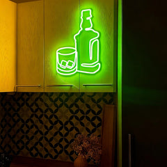 Neon sign of a bottle and glass with ice cubes on a wooden cabinet.