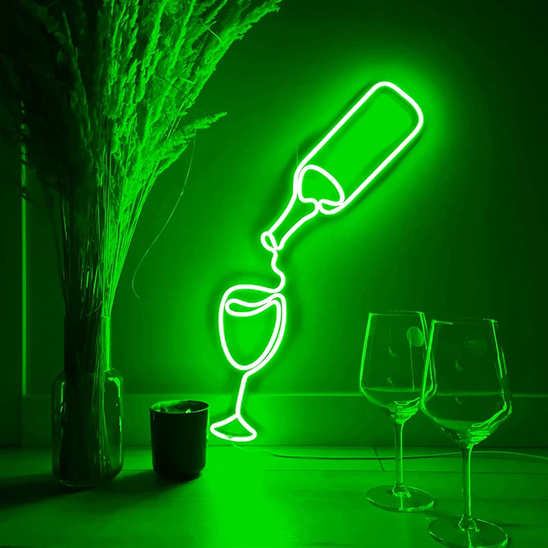 Neon light sculpture of a bottle and glasses on a green background