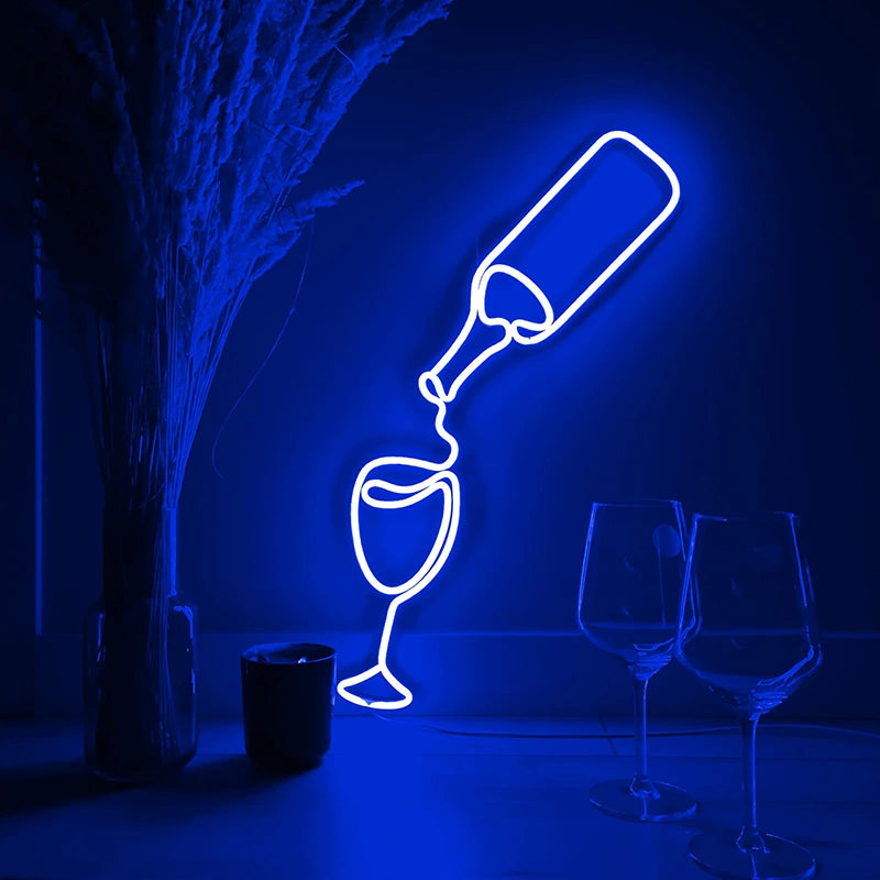 Neon light art of a bottle pouring into a glass with two additional glasses below on a dark background.
