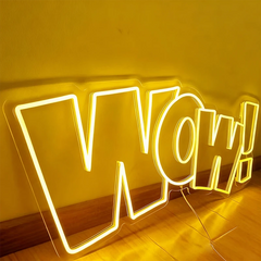 Neon sign with 'WOW!' in bright lemon yellow on a reflective surface.